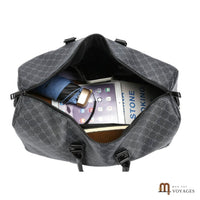 Sac de voyage Dandy ouvert avec tablette, parapluie et carnet