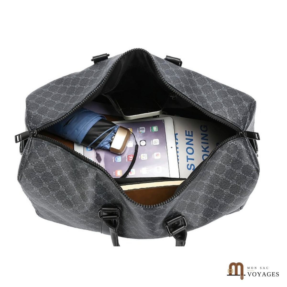 Sac de voyage Dandy ouvert avec tablette, parapluie et carnet