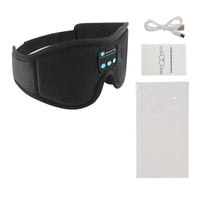 Masque de sommeil Bluetooth Berceuse noir avec ses boutons de commande, câble de charge USB, notice et pochette, sur fond blanc